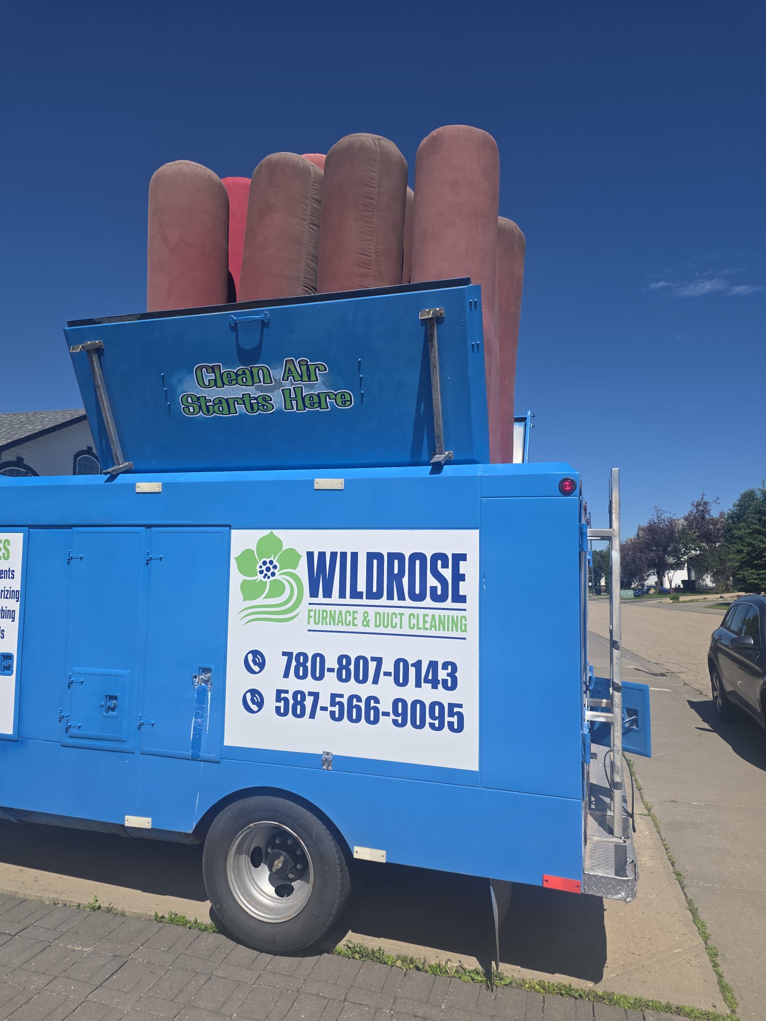 Wildrose Furnace and Duct Cleaning truck with its Clean Air Starts Here lid raised