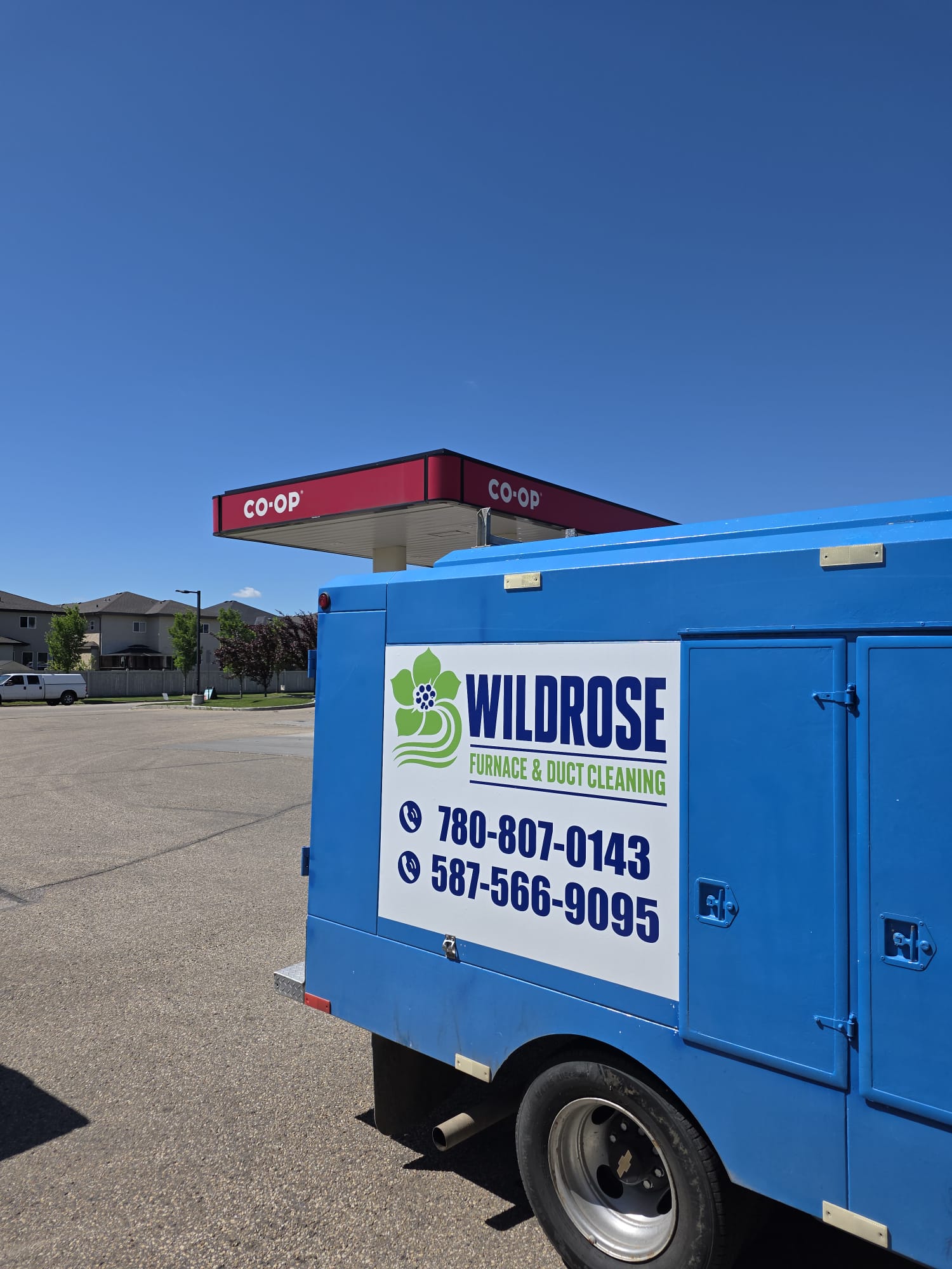 Side of the Wildrose Furnace and Duct Cleaning truck showing the logo and phone numbers